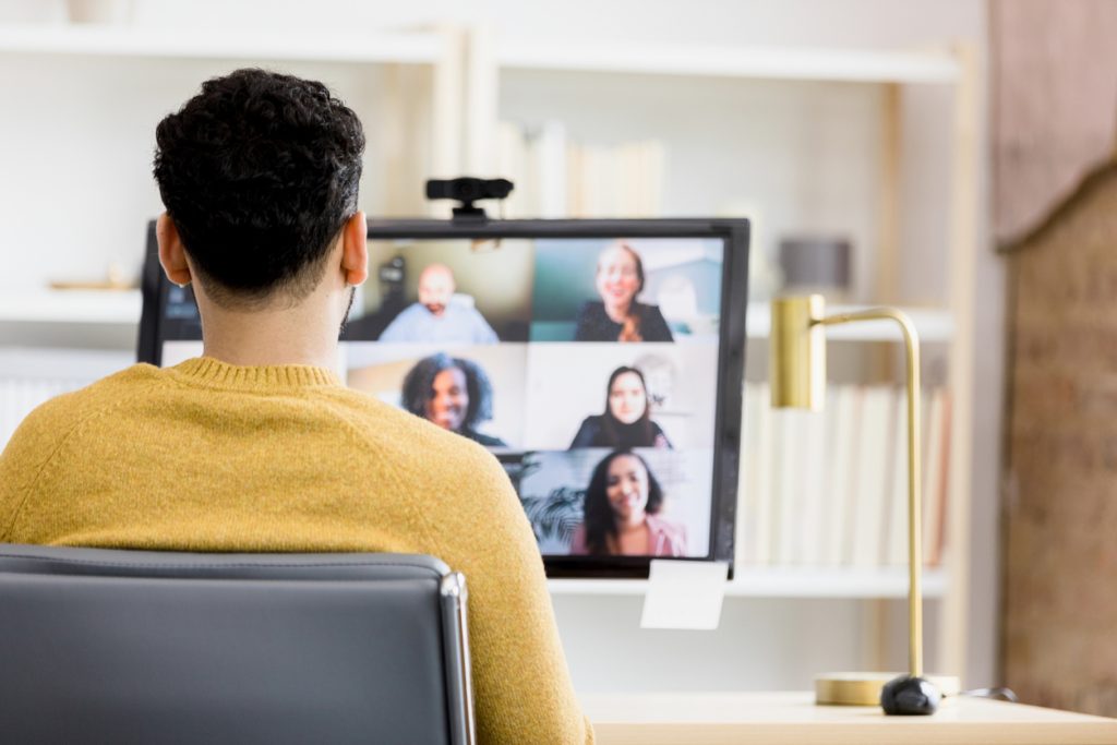 A man sits infront of his computer for a virtual workshop.